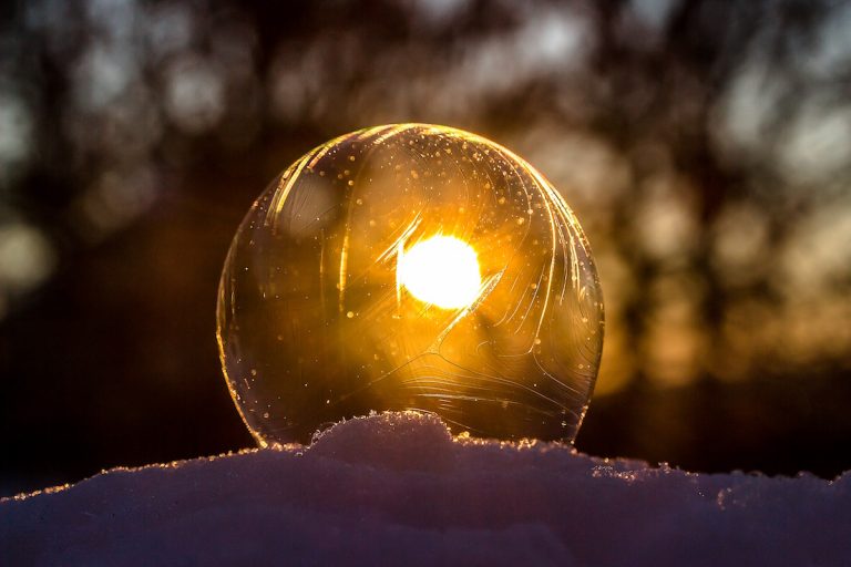 a snow globe sitting on top of a pile of snow.