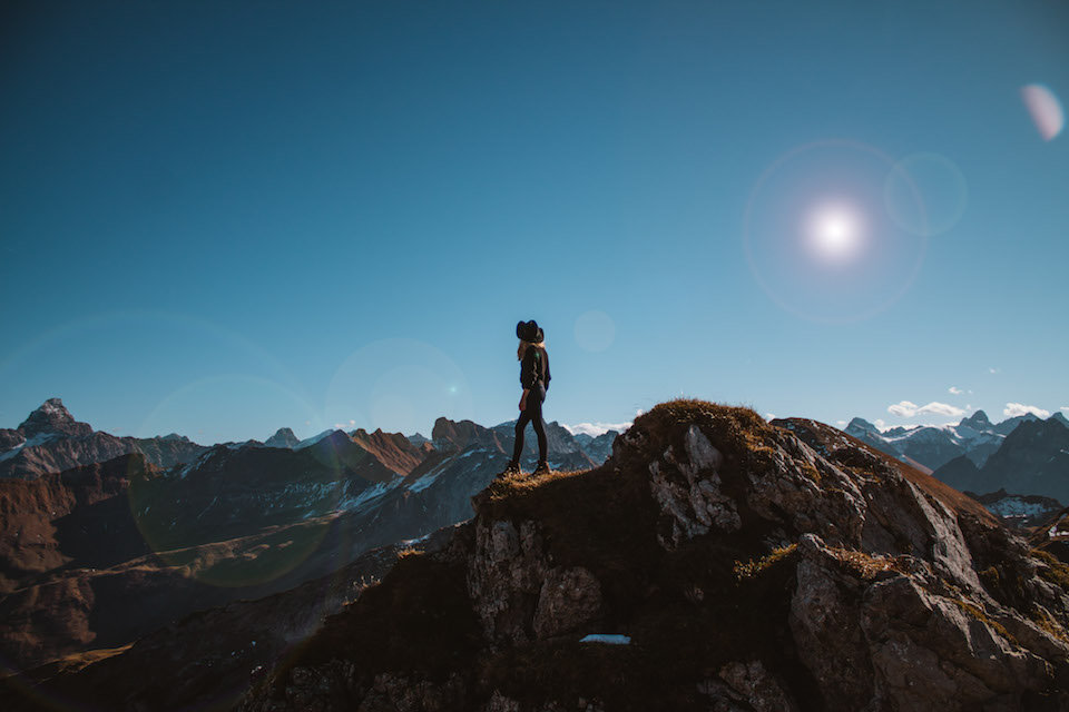 a person standing on top of a mountain.