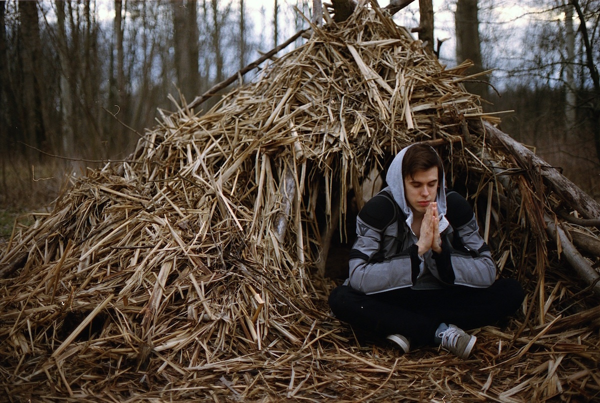 a person sitting in a pile of hay.