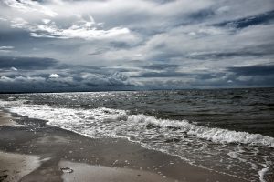 a beach with waves coming in to shore.